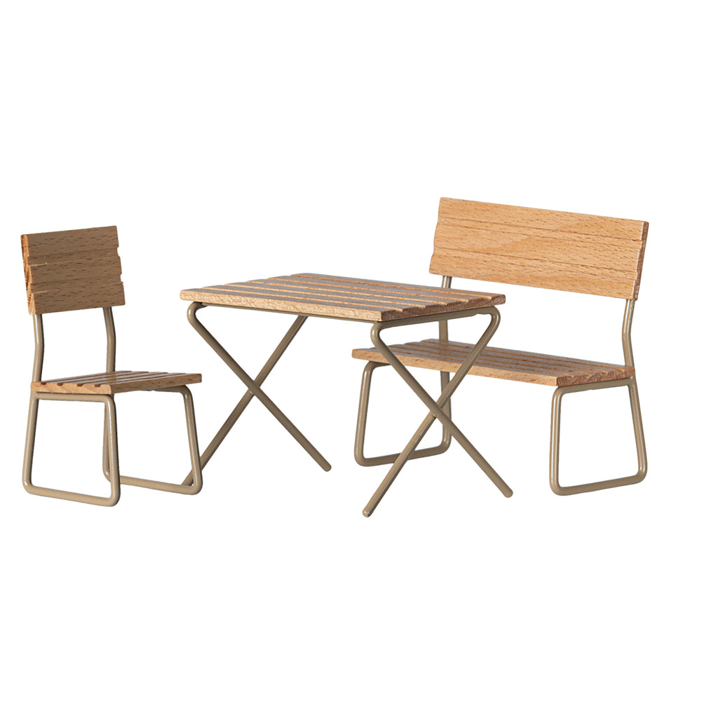 Maileg garden furniture set for mice, including a wooden table, a chair, and a bench with light green metal frames.