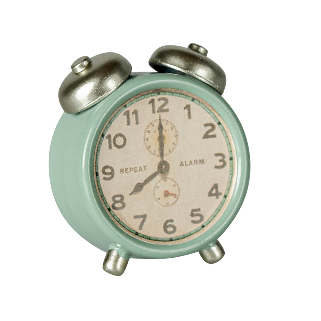 Maileg mouse-sized alarm clock in mint green with silver bells, displaying a vintage-style face with repeat alarm markings.