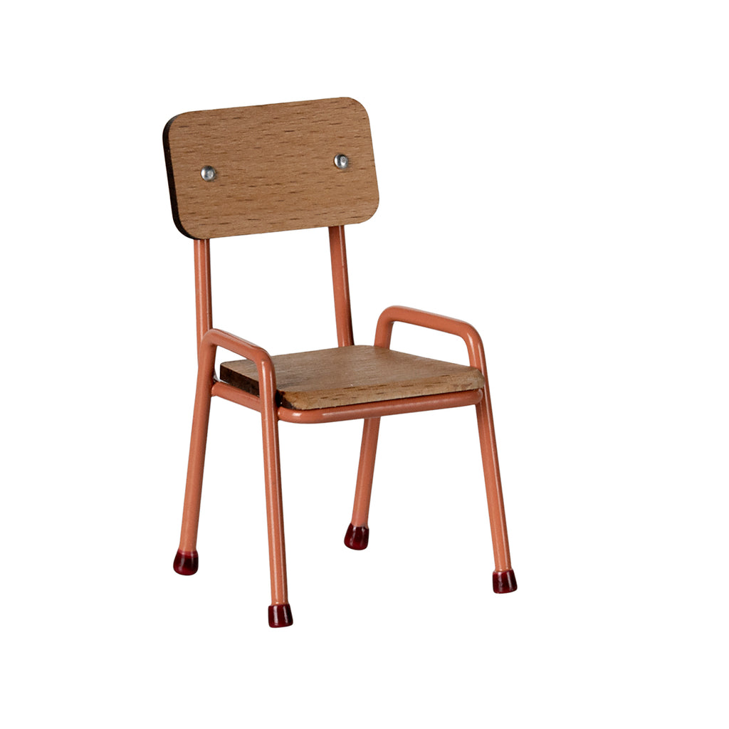 Side view of the Maileg chair in coral, featuring a wooden seat and backrest with a sleek metal frame.