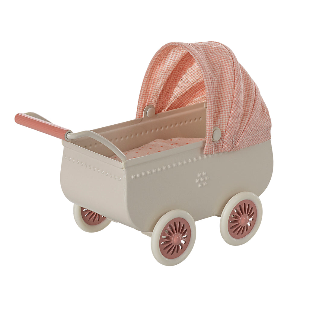 Side view of Maileg coral pram with soft fabric canopy and intricate details."