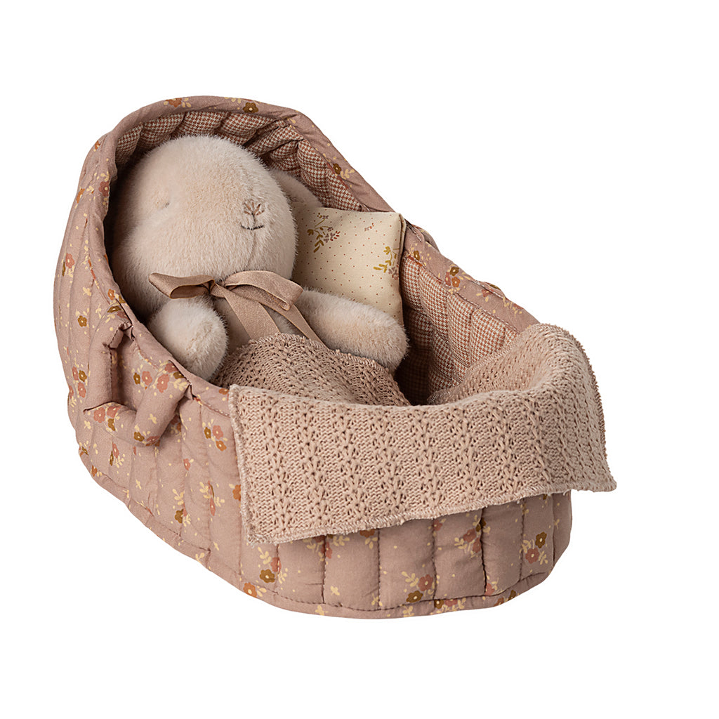 Maileg large carry cot in rose with floral quilted lining, holding a bunny wrapped in a knitted blanket