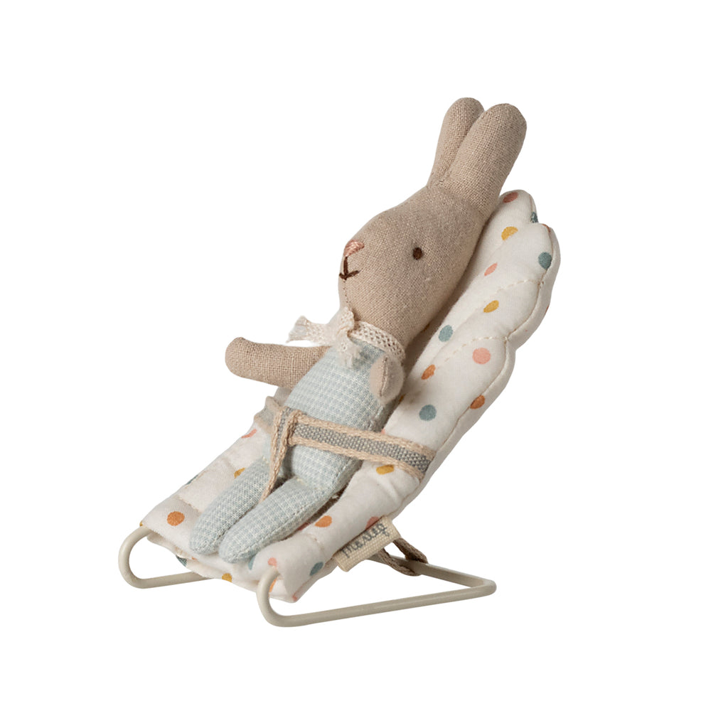 A sweet Maileg My-size babysitter in a multi-dot design, shown with a baby rabbit comfortably sitting inside. A whimsical addition to any Maileg collection.