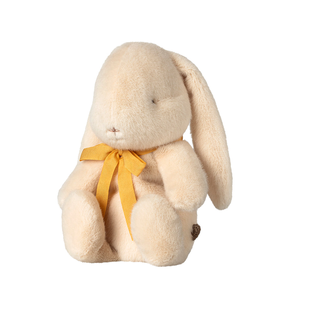 The same Maileg small cream bunny plush with a yellow bow, shown from a side angle to highlight its sweet and cuddly design.