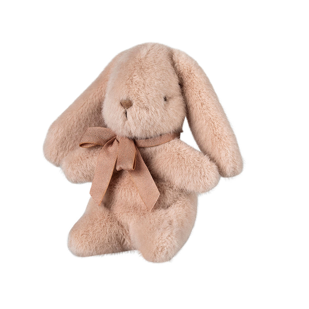 The same mini Maileg bunny in light powder, showcasing its delicate pink bow and sitting pose from a new perspective.