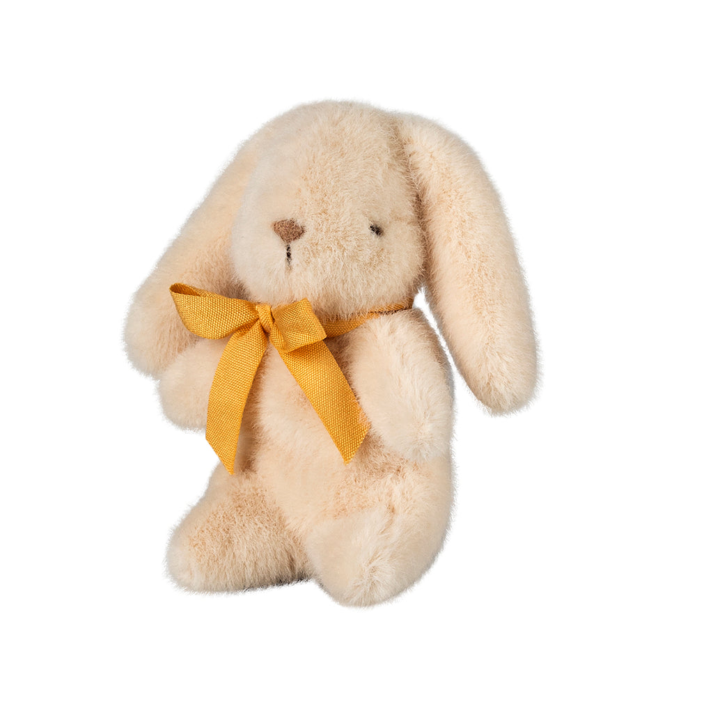 The same mini Maileg bunny in cream, showcasing its delicate yellow bow and sitting pose from a new perspective