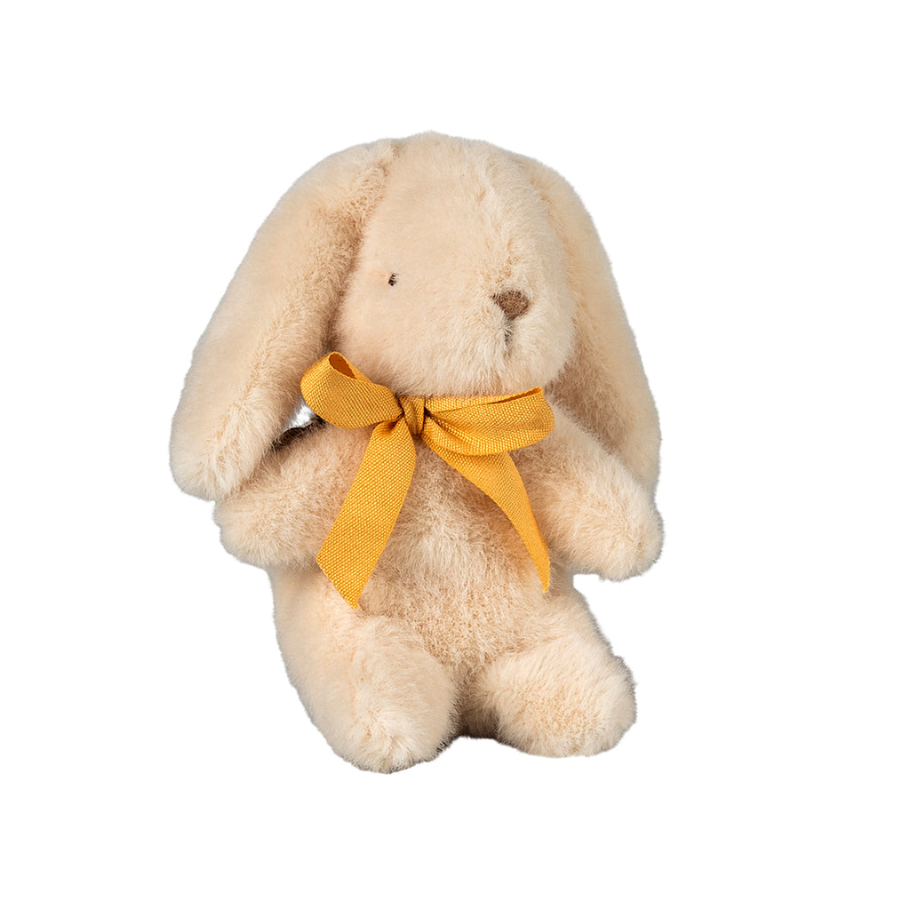 A sweet mini Maileg bunny in a soft cream colour, sitting gracefully with a charming yellow bow tied around its neck