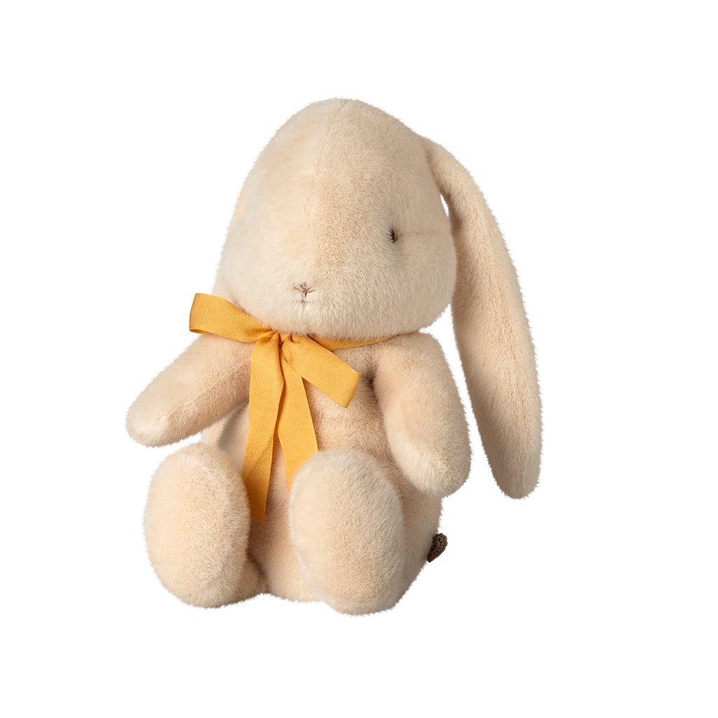 The same Maileg medium bunny in cream, showcasing its lovely yellow bow and sitting pose from another perspective.