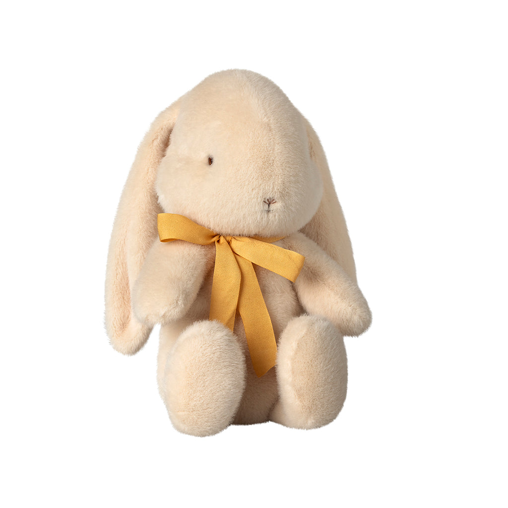 A charming Maileg medium bunny in a soft cream colour, sitting gracefully with a cheerful yellow bow tied around its neck