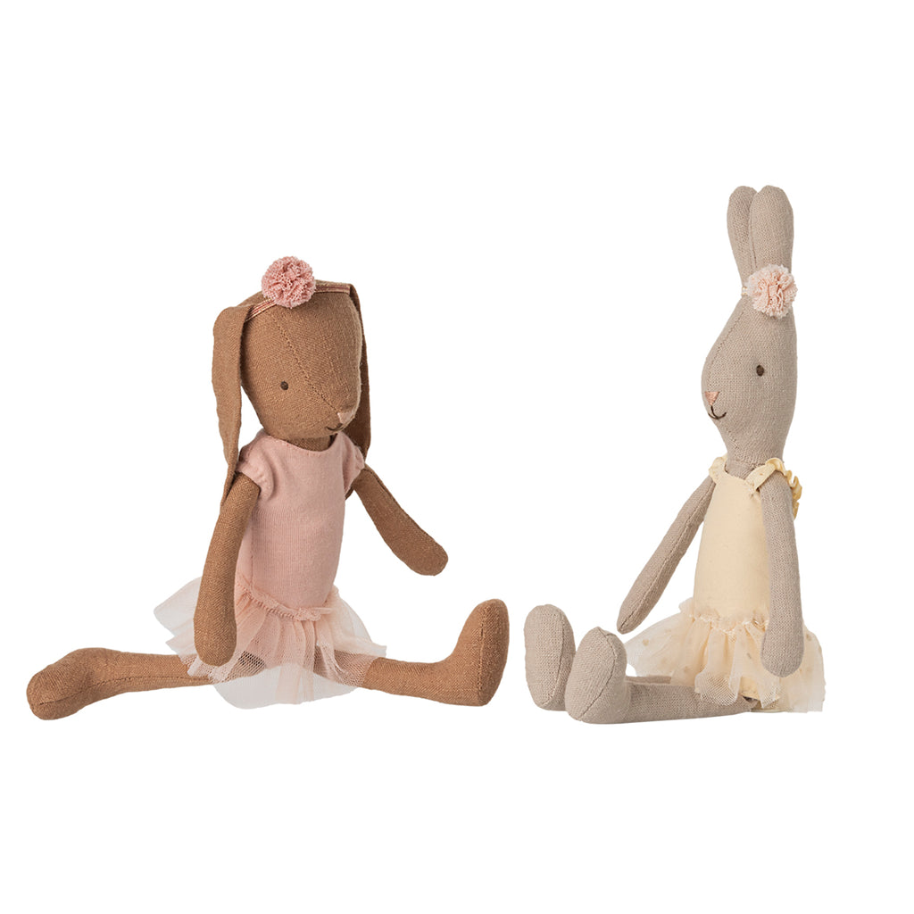 Two Maileg bunnies showcasing their ballet outfits while sitting in elegant ballet poses