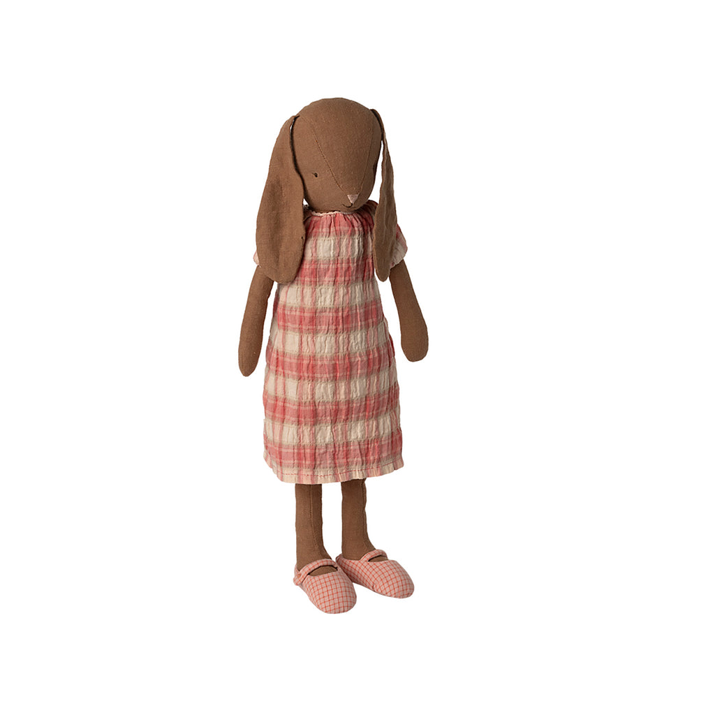 Maileg size 3 chocolate brown bunny dressed in a pink checked dress with matching gingham shoes, standing upright.