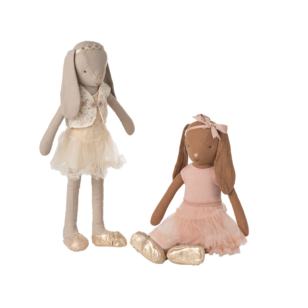 Maileg Bunny size 3 in chocolate brown, wearing a rose ballet suit and tulle skirt, sitting beside a cream bunny dressed in an elegant cream ballet outfit with golden ballet slippers.