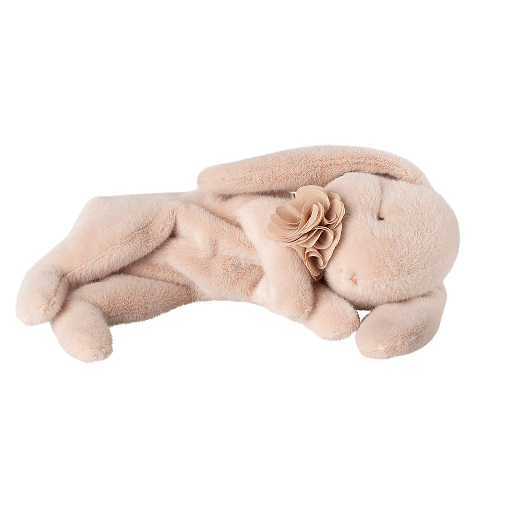 Maileg sleeping bunny plush in powder pink, lying on its side with a flower accessory on its neck