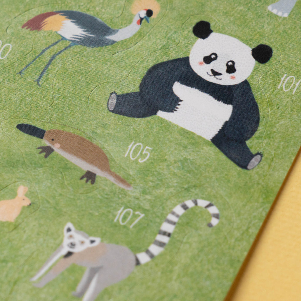 Close-up of Londji Animal World sticker sheet featuring illustrated animals like a panda, platypus, and lemur.