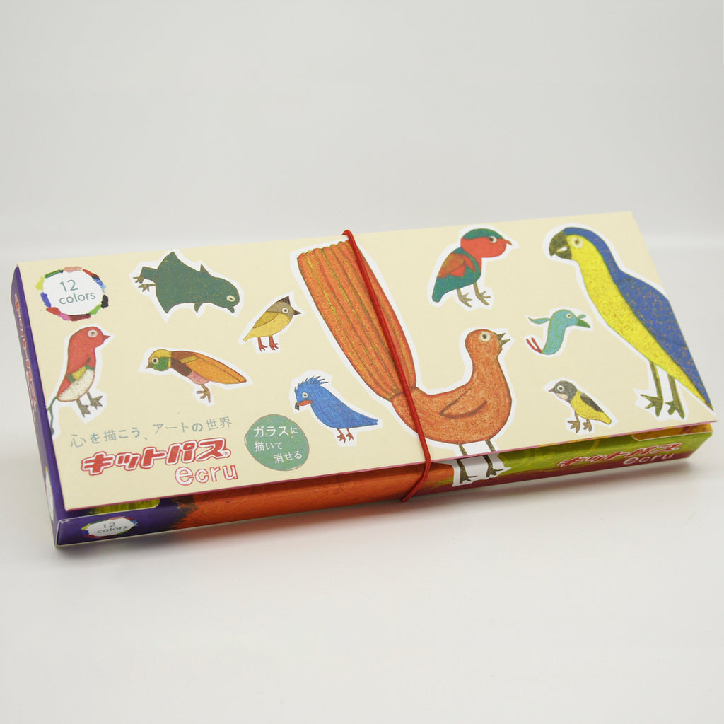 Kitpas Ecru Crayons 12-pack in a beautifully illustrated box featuring hand-drawn birds, with a red elastic band securing the packaging.