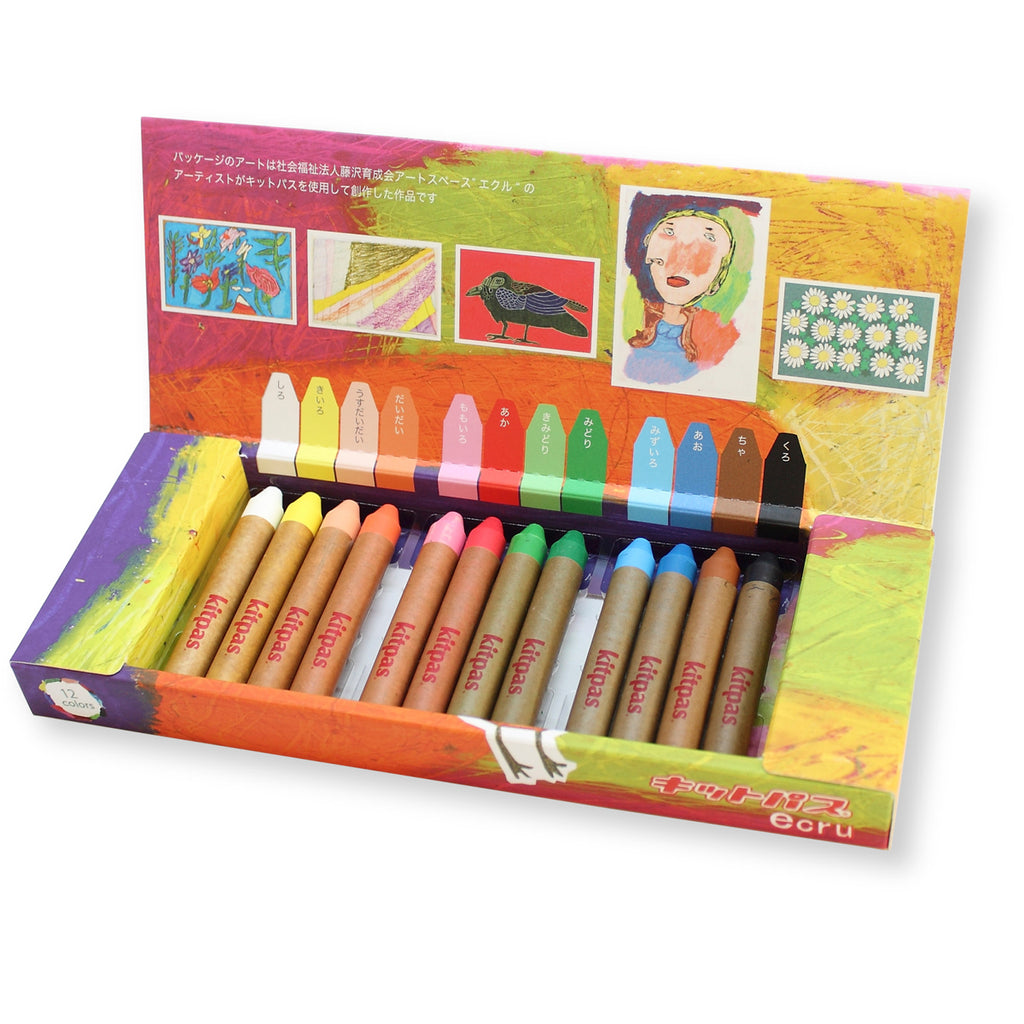 Open box of Kitpas Ecru Crayons 12-pack, displaying vibrant colours with Japanese labels, set against an artistic and colourful background