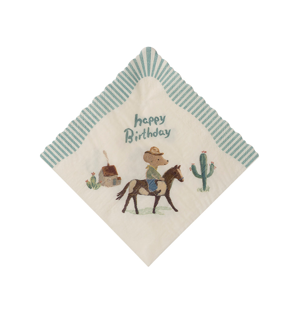 Maileg birthday napkin with a cowboy mouse trotting on a horse in front of a small house and cacti, under the words 'Happy Birthday'.