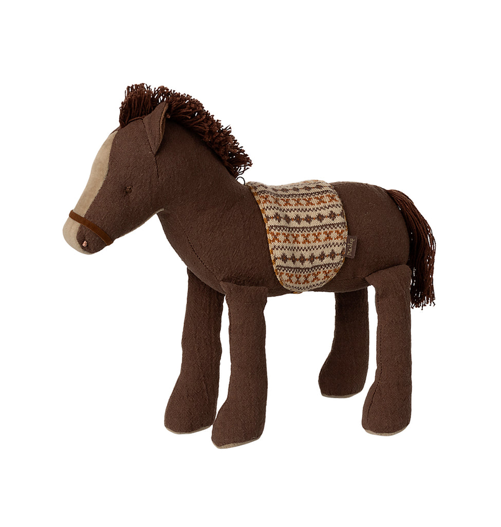 Maileg medium brown pony standing up, featuring a cotton string mane and tail with a knitted patterned saddle.