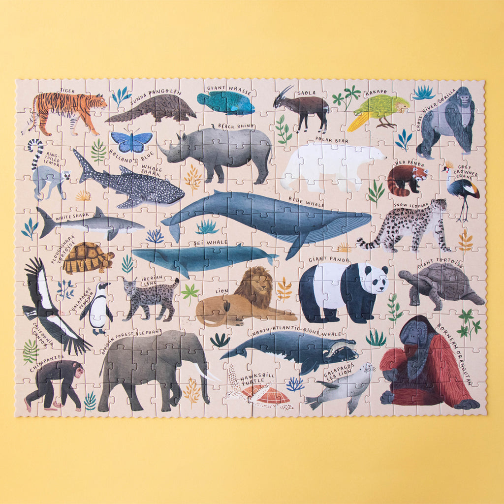 Completed "LIFE" puzzle displaying various endangered species like pandas, tigers, and whales.