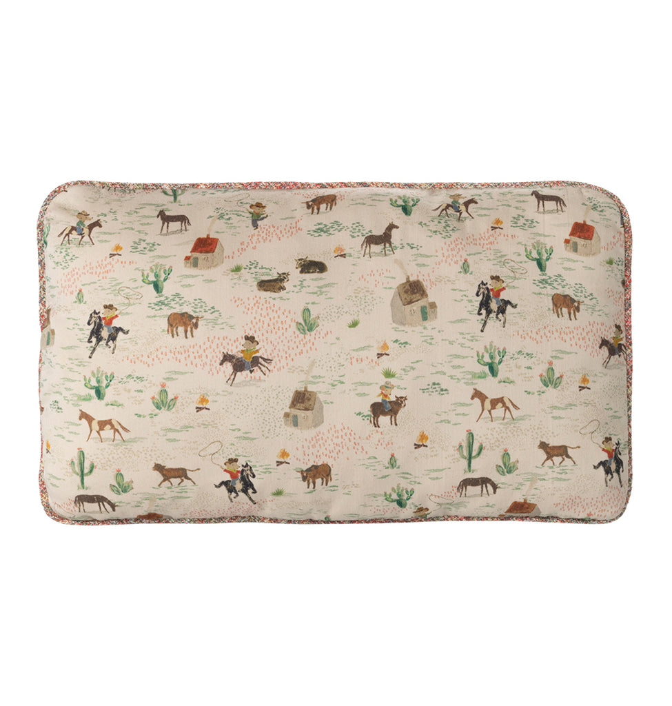 Maileg pony cushion featuring a cream background with illustrations of ponies, cacti, campfires and houses